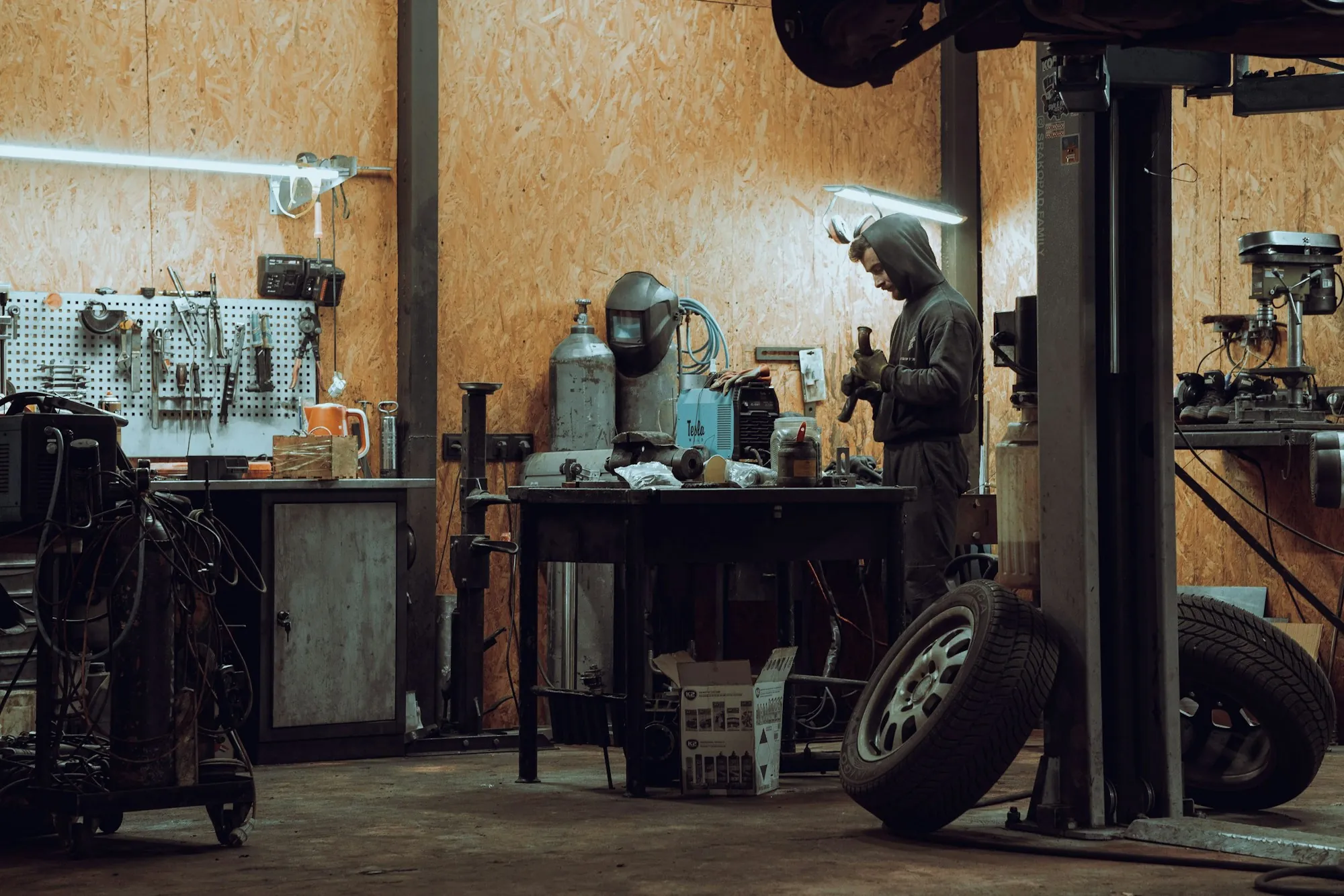 Sedan clamped to a frame straightening bench with pulling towers and chains attached