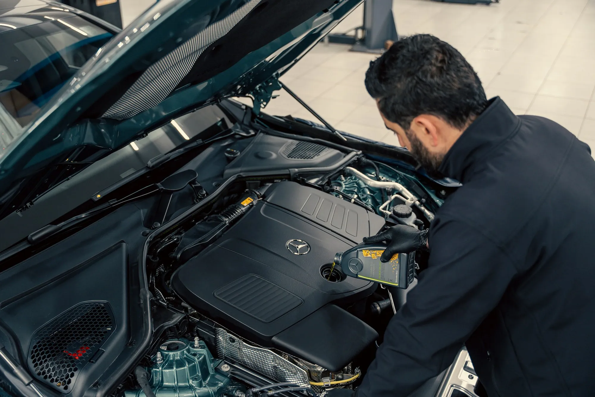 Mechanic using a wrench in a car's engine bay