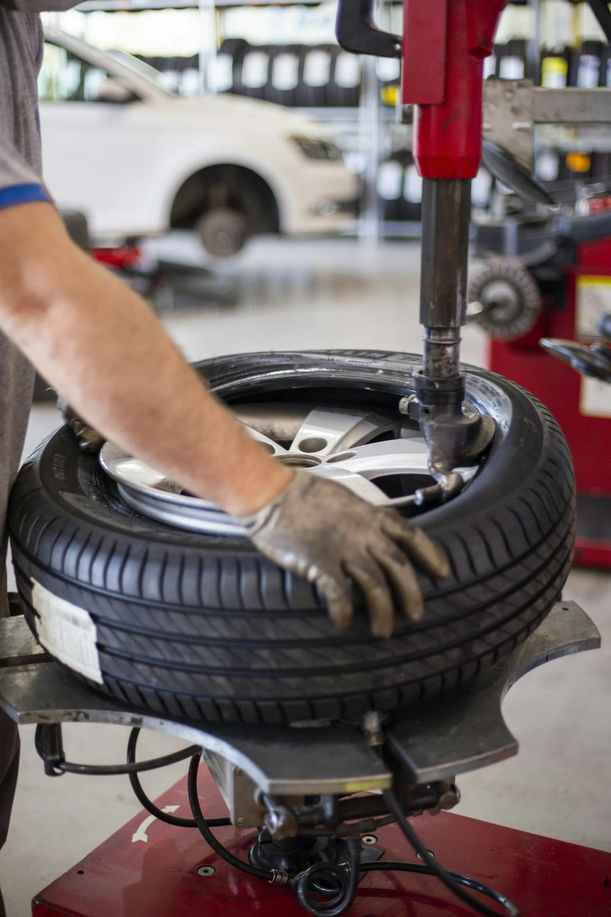 Hands changing a tire on a wheel machine